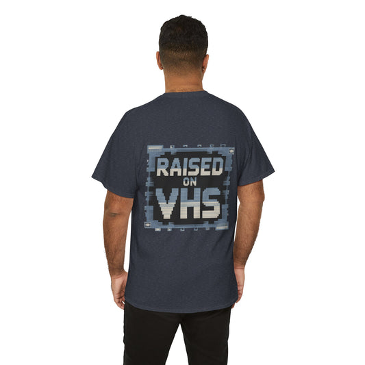 Person wearing a dark blue t-shirt with 'Raised on VHS' text on the back, standing against a white background.