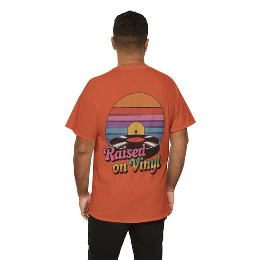 Person wearing an orange t-shirt with a 'Raised on Vinyl' design on the back.