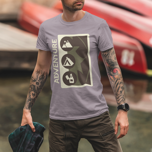 Man wearing a gray t-shirt with a graphic design, standing in front of boats.