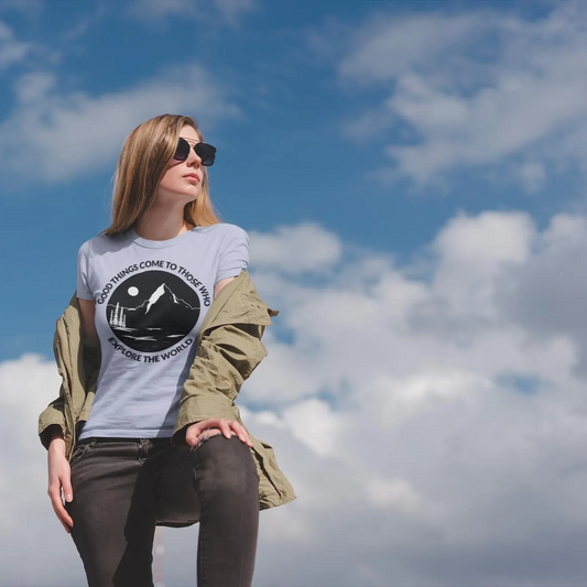 Woman wearing a t-shirt with a graphic design against a blue sky with clouds