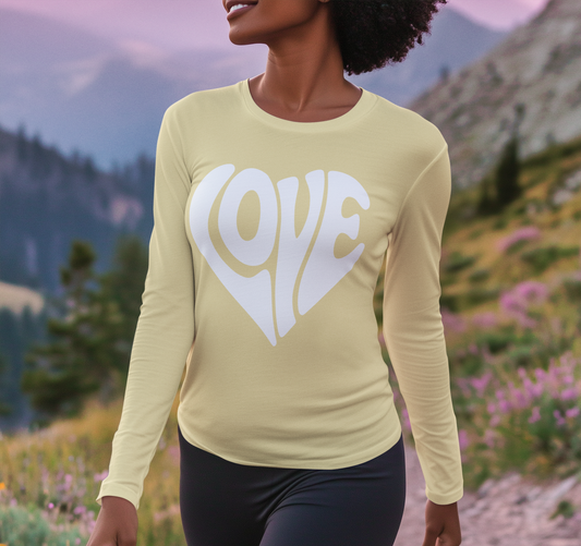 Person wearing a yellow long-sleeve shirt with 'LOVE' printed on it against a mountainous background.