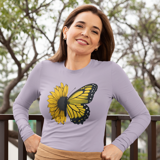 Woman wearing a purple long-sleeve shirt with a butterfly graphic outdoors.