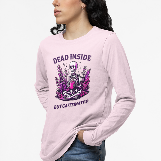 Person wearing a pink long-sleeve shirt with a graphic design and text.