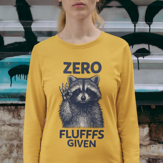 Person wearing a yellow long-sleeve shirt with a raccoon graphic and text in front of a graffiti-covered wall.