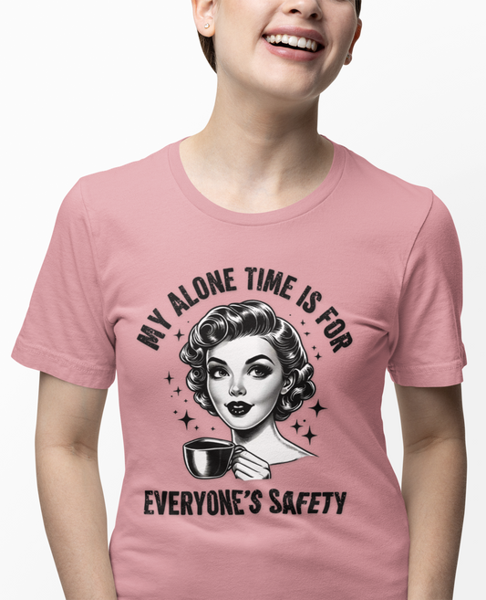 Person wearing a pink t-shirt with a graphic design and text.