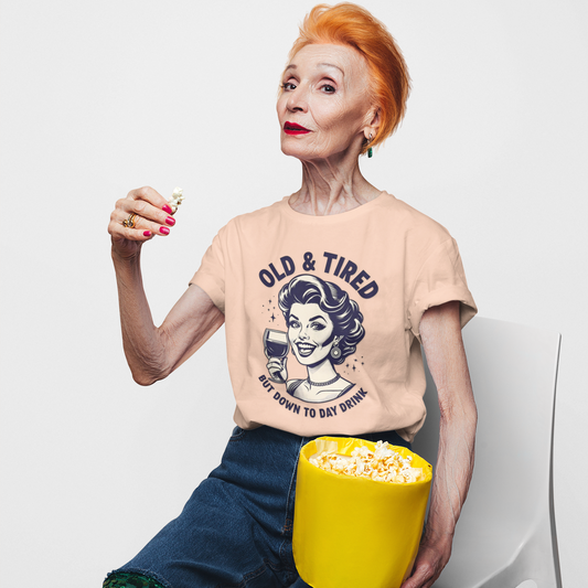Person wearing a t-shirt with a graphic design, sitting with a bucket of popcorn on a white background