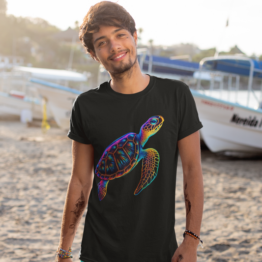 Man wearing a black t-shirt with a colorful turtle design on a beach.