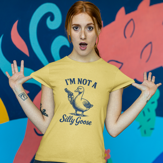 Person wearing a yellow t-shirt with a graphic and text, standing against a colorful abstract background.