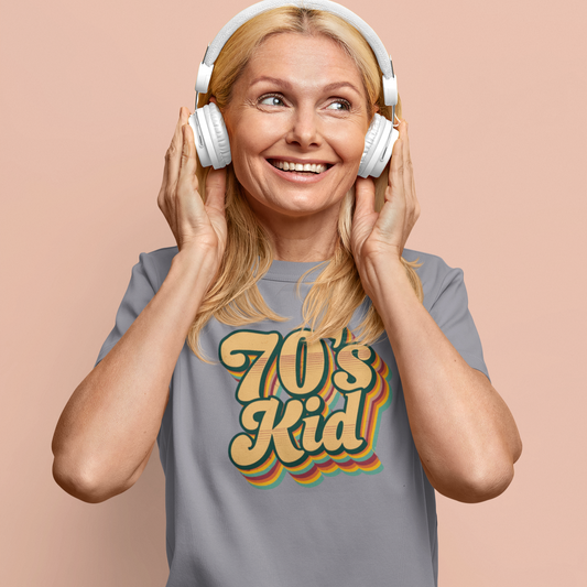 Woman wearing headphones and a '70s Kid' t-shirt on a beige background