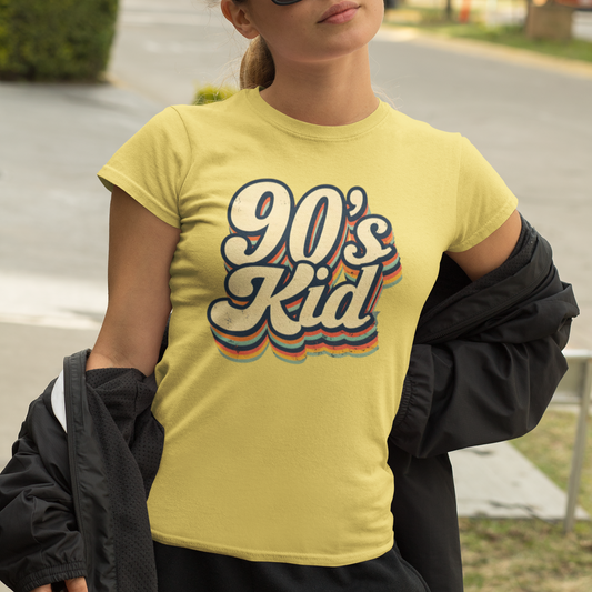 Woman wearing a yellow t-shirt with '90's Kid' text, standing outdoors.
