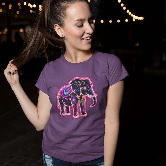 Woman wearing a purple t-shirt with a colorful elephant design at night.