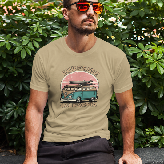Man wearing a t-shirt with a graphic design of a van and text, sitting outdoors.