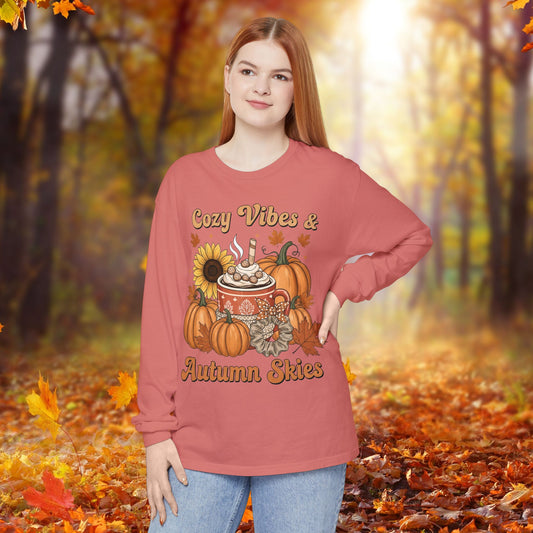 Person wearing a long-sleeve shirt with autumn-themed design in an autumn forest setting
