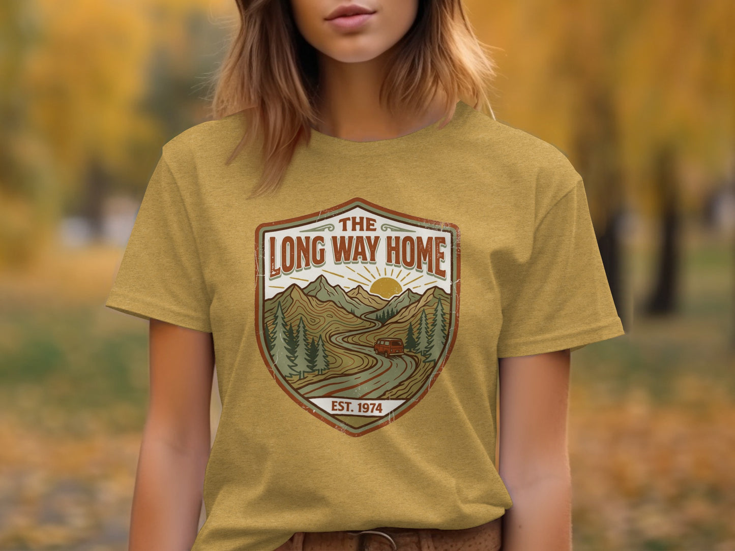 Rugged The Long Way Home | Vintage Adventure Wilderness Shirt: Yellow t-shirt with "The Long Way Home" logo featuring mountains, trees, and a car.