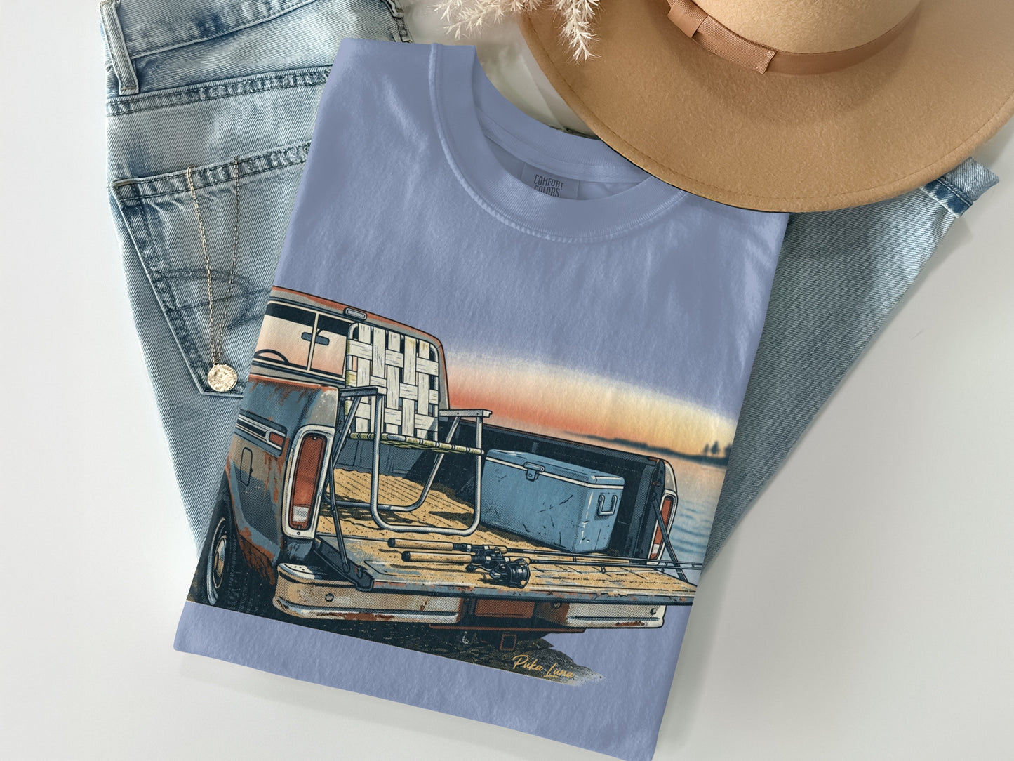 Light blue t-shirt featuring a vintage truck with fishing gear in the bed.