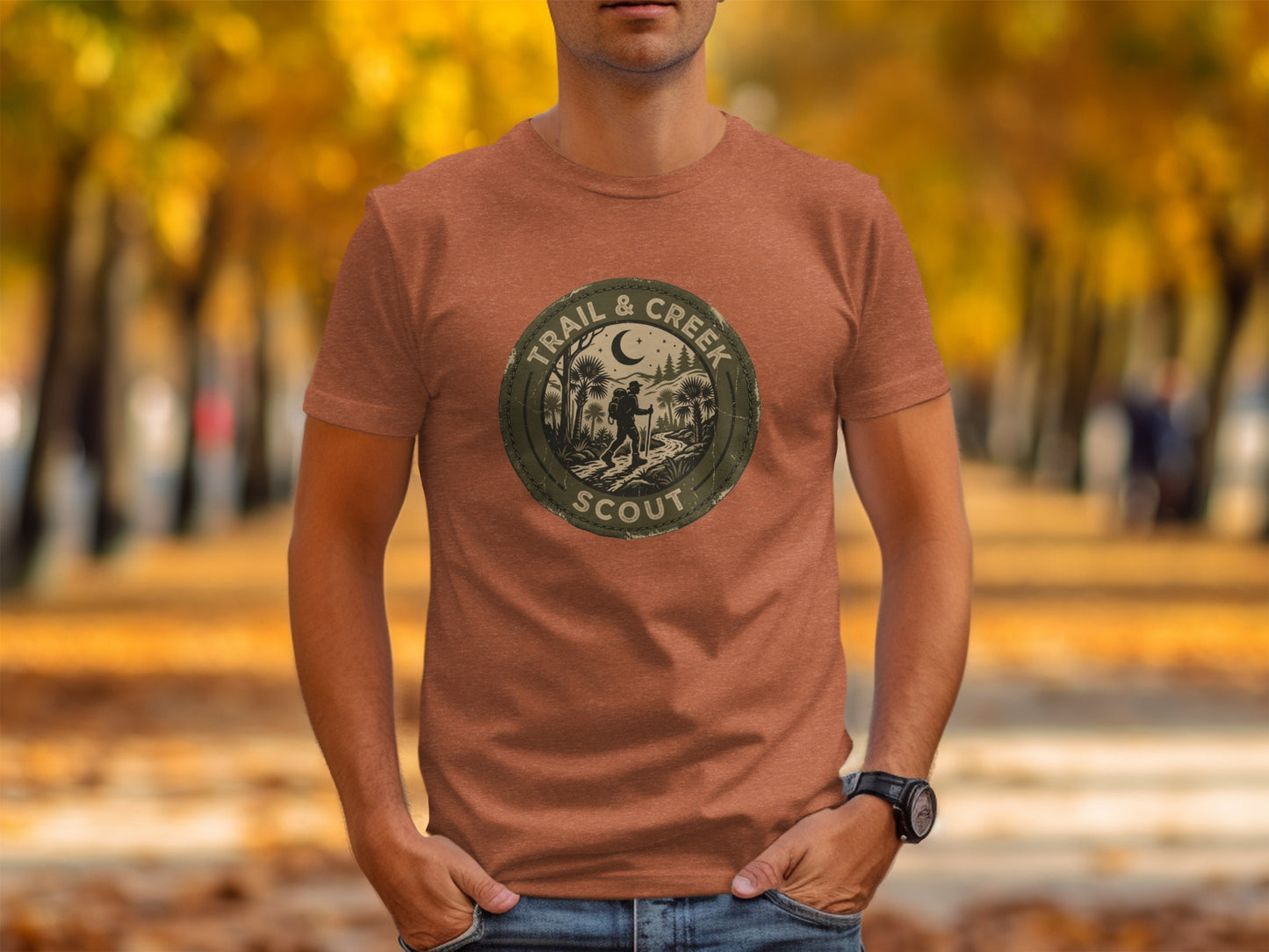 Heritage Trail & Creek Scout Adventure Nomad Tee: Brown t-shirt with circular "Trail & Creek Scout" logo featuring a hiker and trees.
