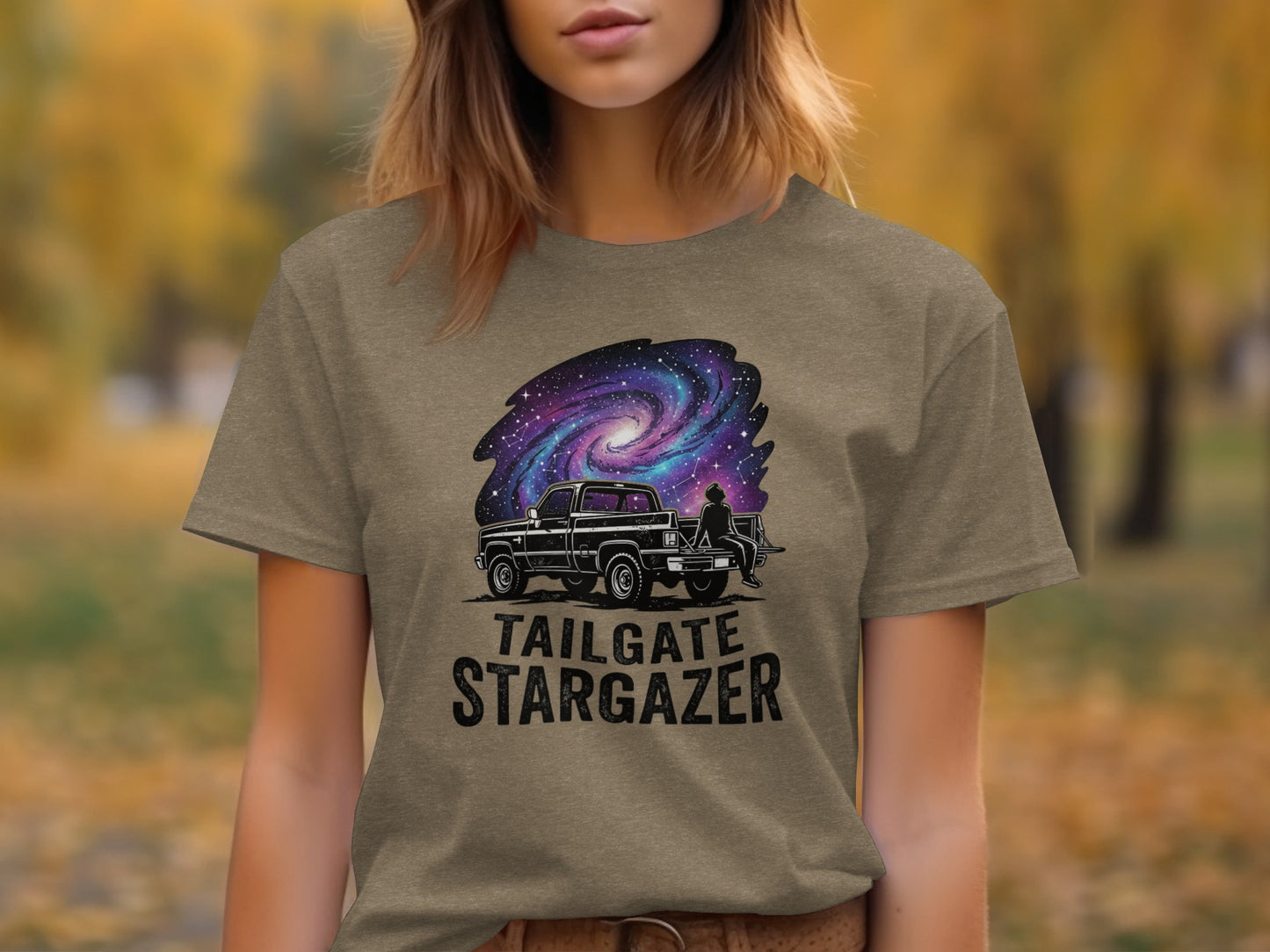 Heritage Cosmic Tailgate Stargazer Nomad Tee: T-shirt graphic of a pickup truck with a starry galaxy and "TAILGATE STARGAZER" text.