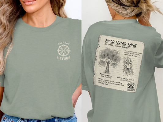 T-shirt with "Take the Detour" on front, back has field notes on palm and orchid.