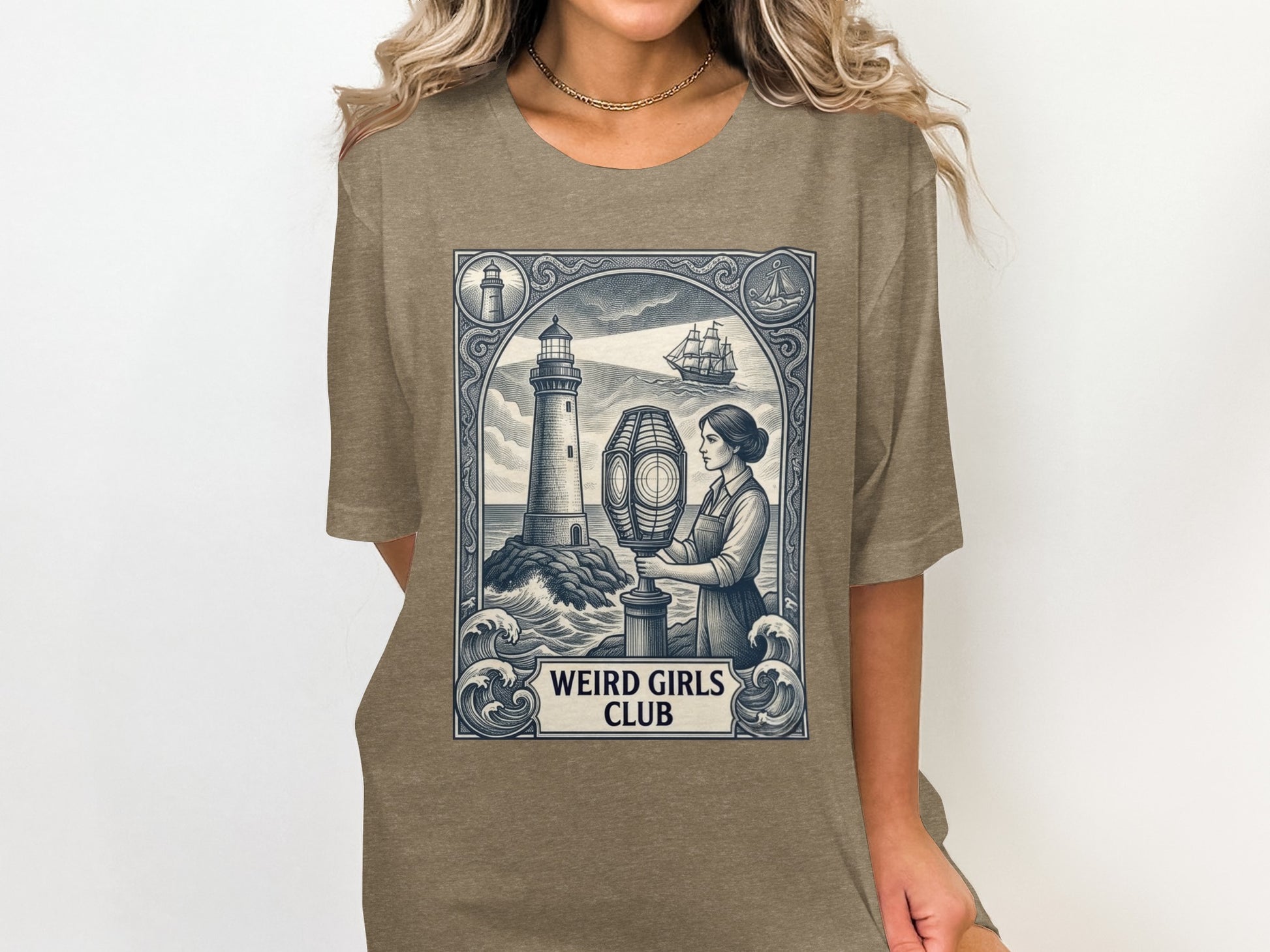 T-shirt featuring a lighthouse, ship, and woman, with "WEIRD GIRLS CLUB" text.