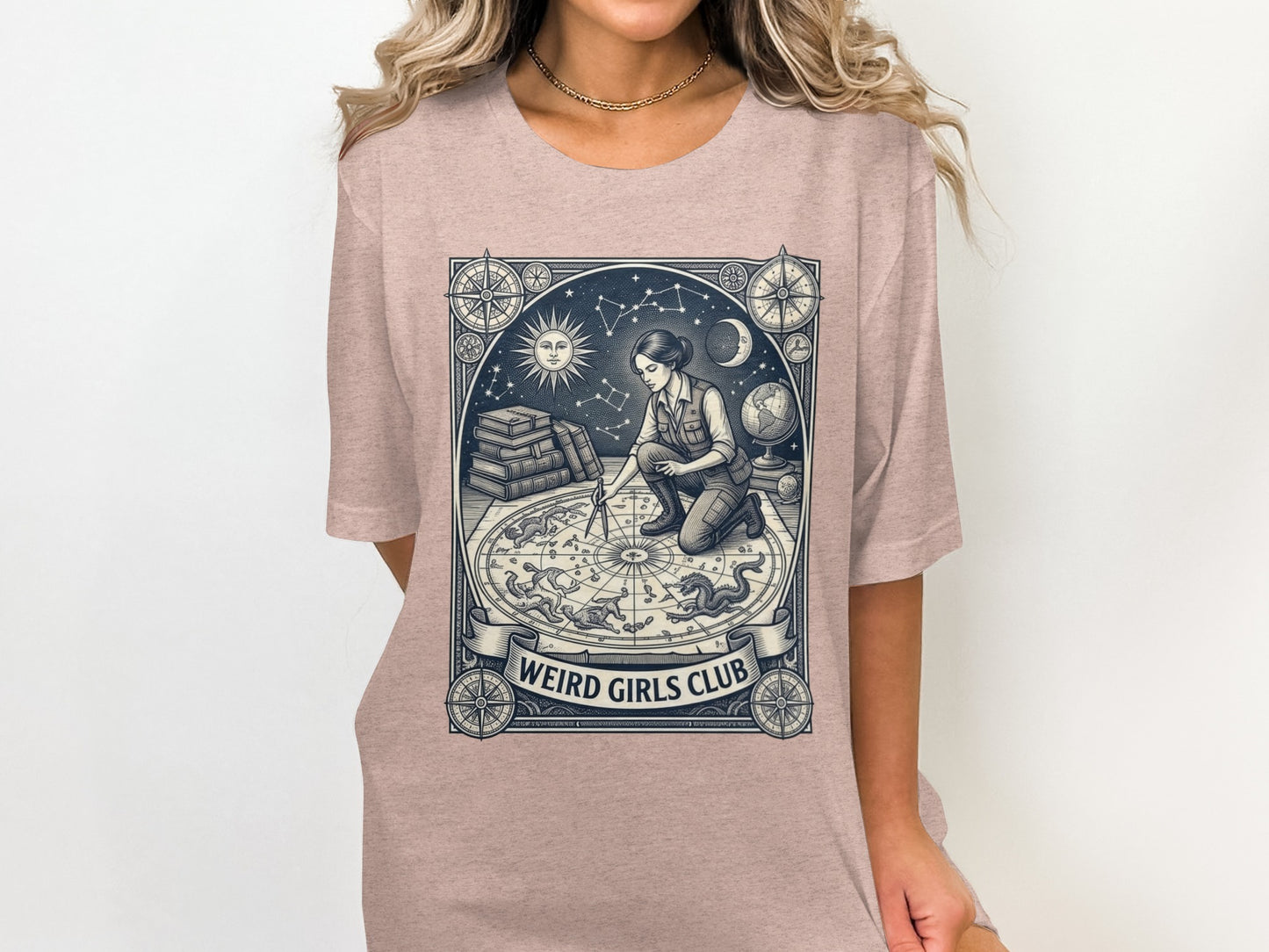 T-shirt graphic of a person working with a celestial map, "Weird Girls Club" text.