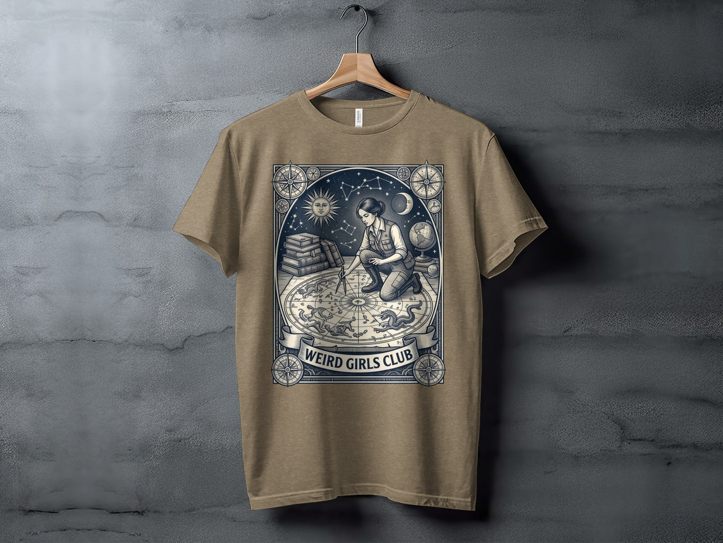 T-shirt graphic: woman examines celestial map with "Weird Girls Club" banner.