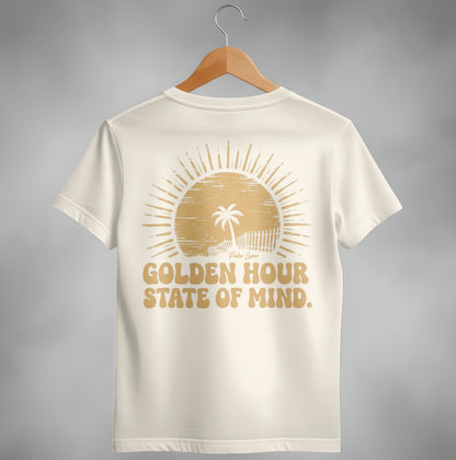 Cream t-shirt with golden sun and palm tree graphic and "Golden Hour State of Mind" text.