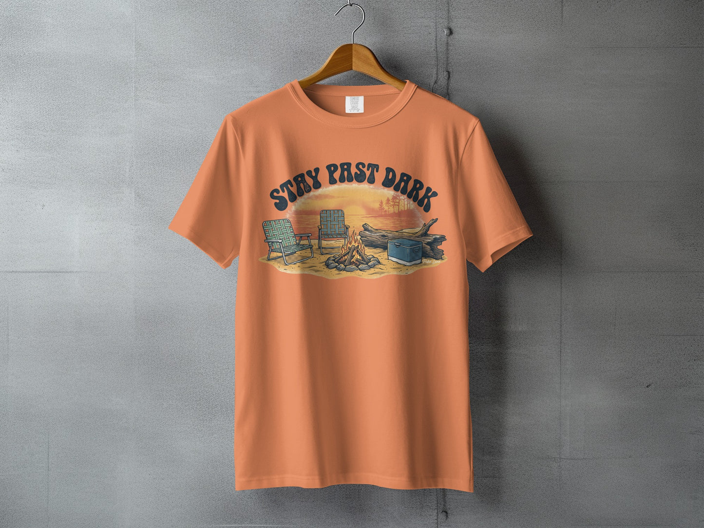 Orange t-shirt with "STAY PAST DARK" text and campfire scene graphic.
