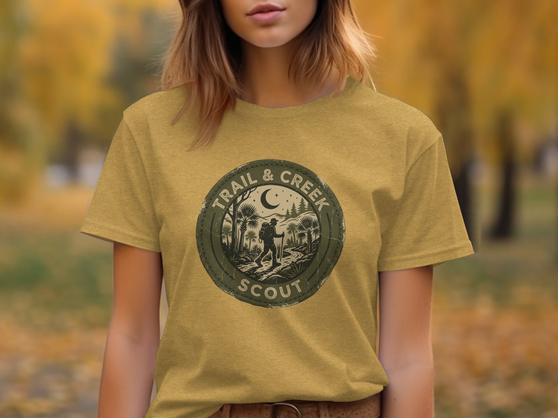 Heritage Trail & Creek Scout Adventure Nomad Tee: T-shirt with circular "Trail & Creek Scout" emblem featuring hiker and trees.