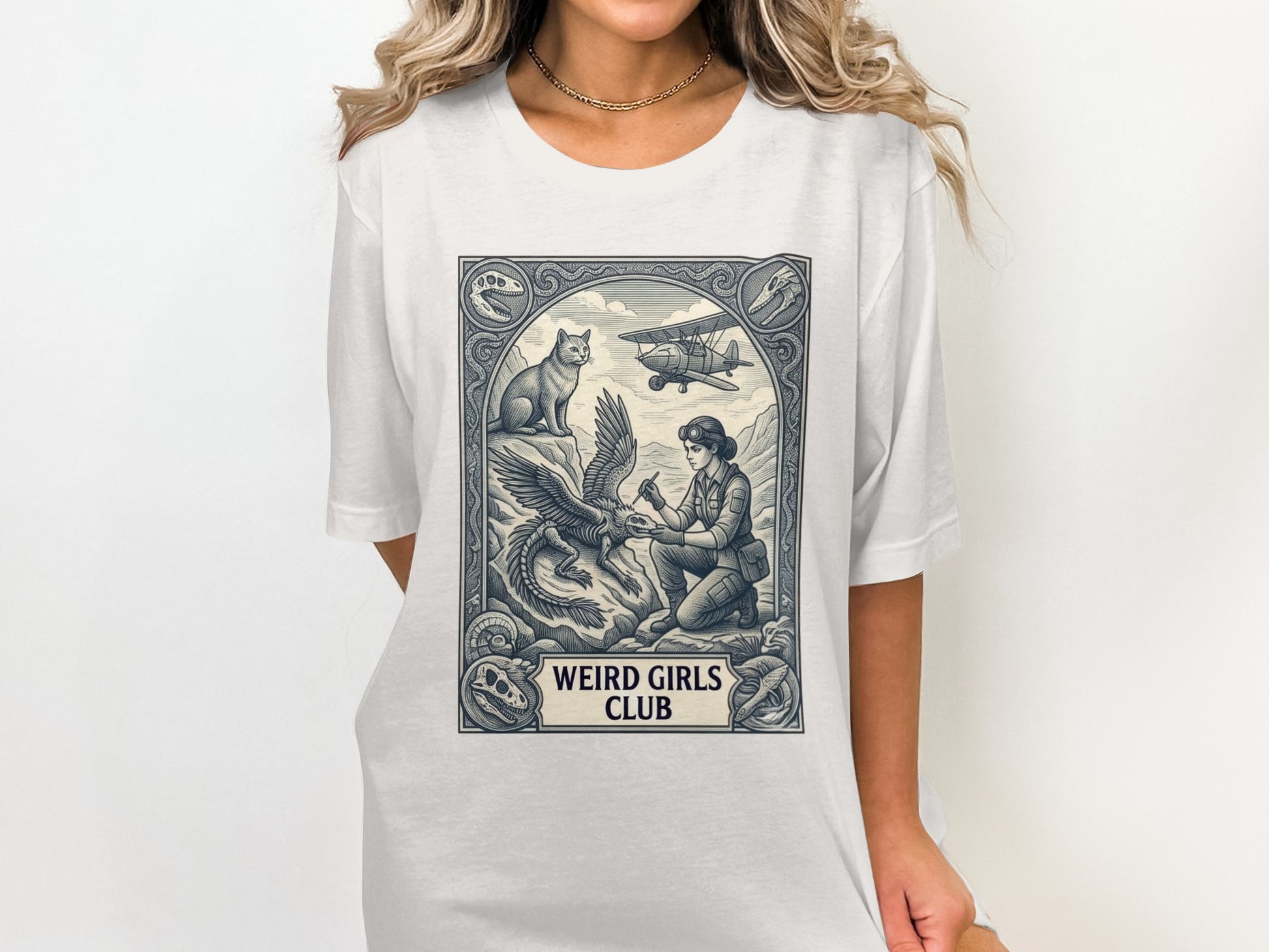 Woman with dragon and cat, vintage airplane above, "WEIRD GIRLS CLUB" text.