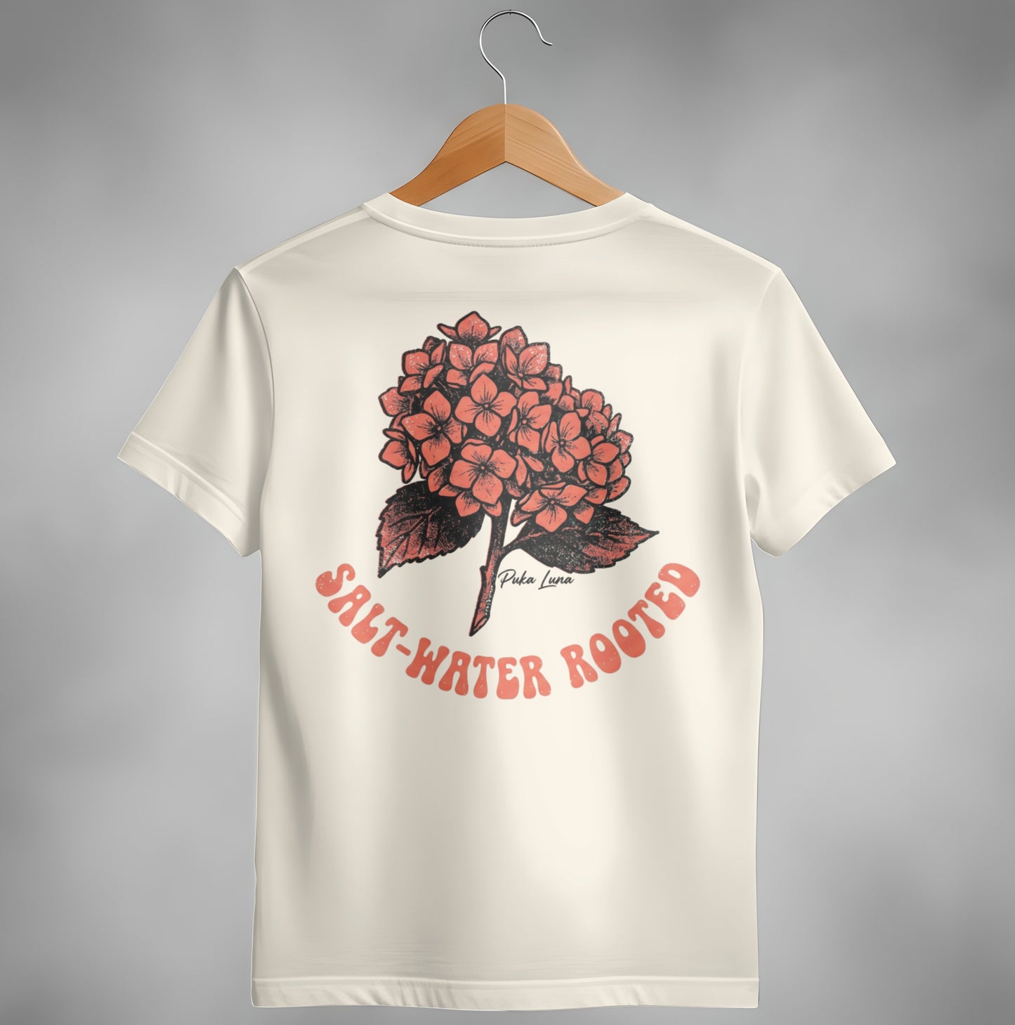 Cream t-shirt with a coral hydrangea graphic and "SALT-WATER ROOTED" text.