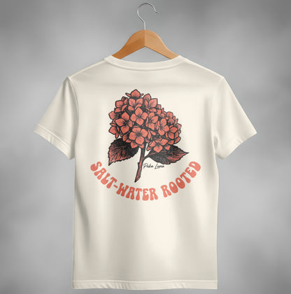 Cream t-shirt with a coral hydrangea graphic and "SALT-WATER ROOTED" text.