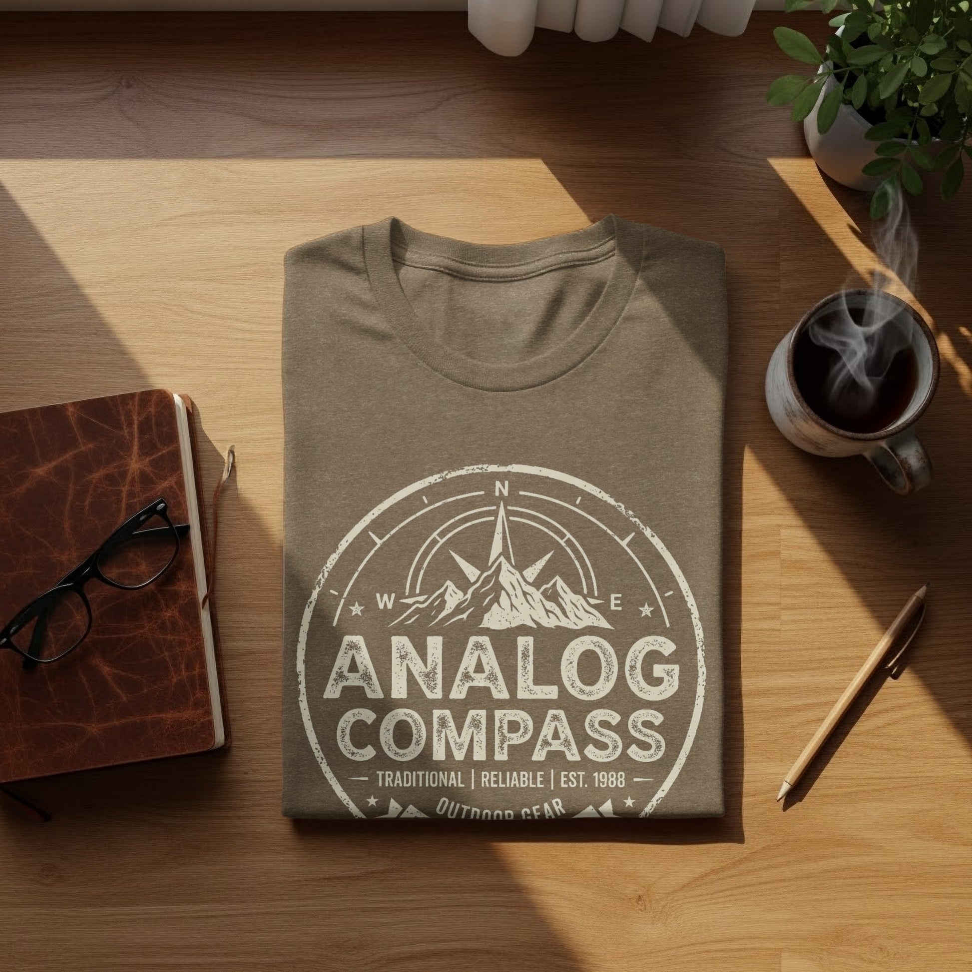 Analog Compass Heritage: The Explorer's Adventure Tee: Brown t-shirt with "Analog Compass" logo and compass design.