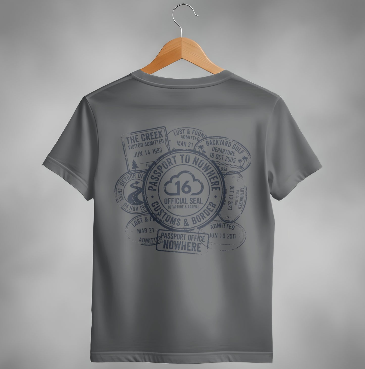 Dark gray t-shirt with passport stamp graphic and "Passport to Nowhere" text.