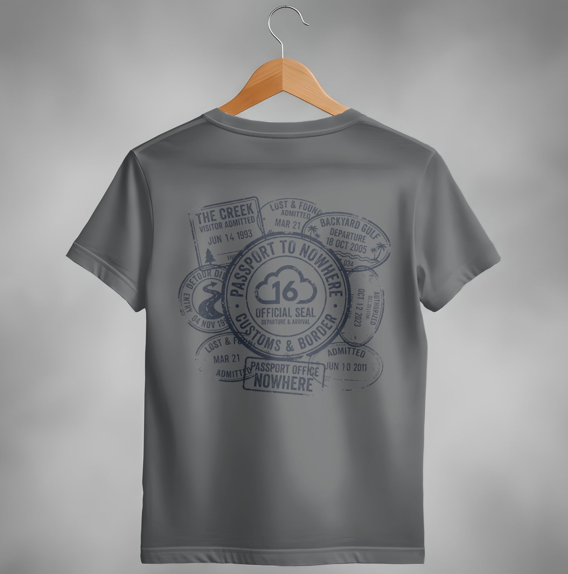Dark gray t-shirt with passport stamp graphic and "Passport to Nowhere" text.