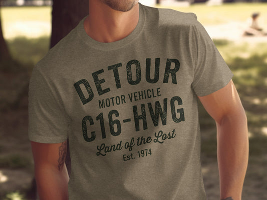 T-shirt with "DETOUR MOTOR VEHICLE C16-HWG Land of the Lost Est. 1974" graphic.
