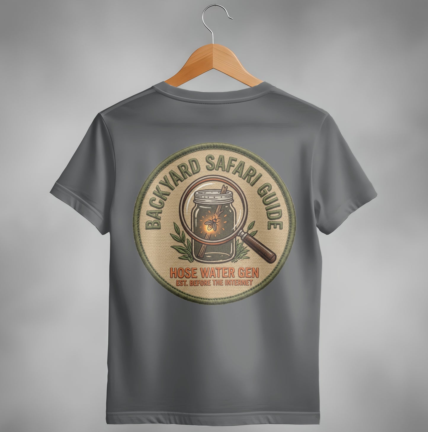 Backyard Safari Guide Hose Water Gen embroidered patch with magnifying glass and bug.