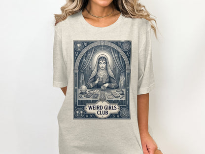 Woman wearing a t-shirt with a tarot reader illustration and "Weird Girls Club" text.