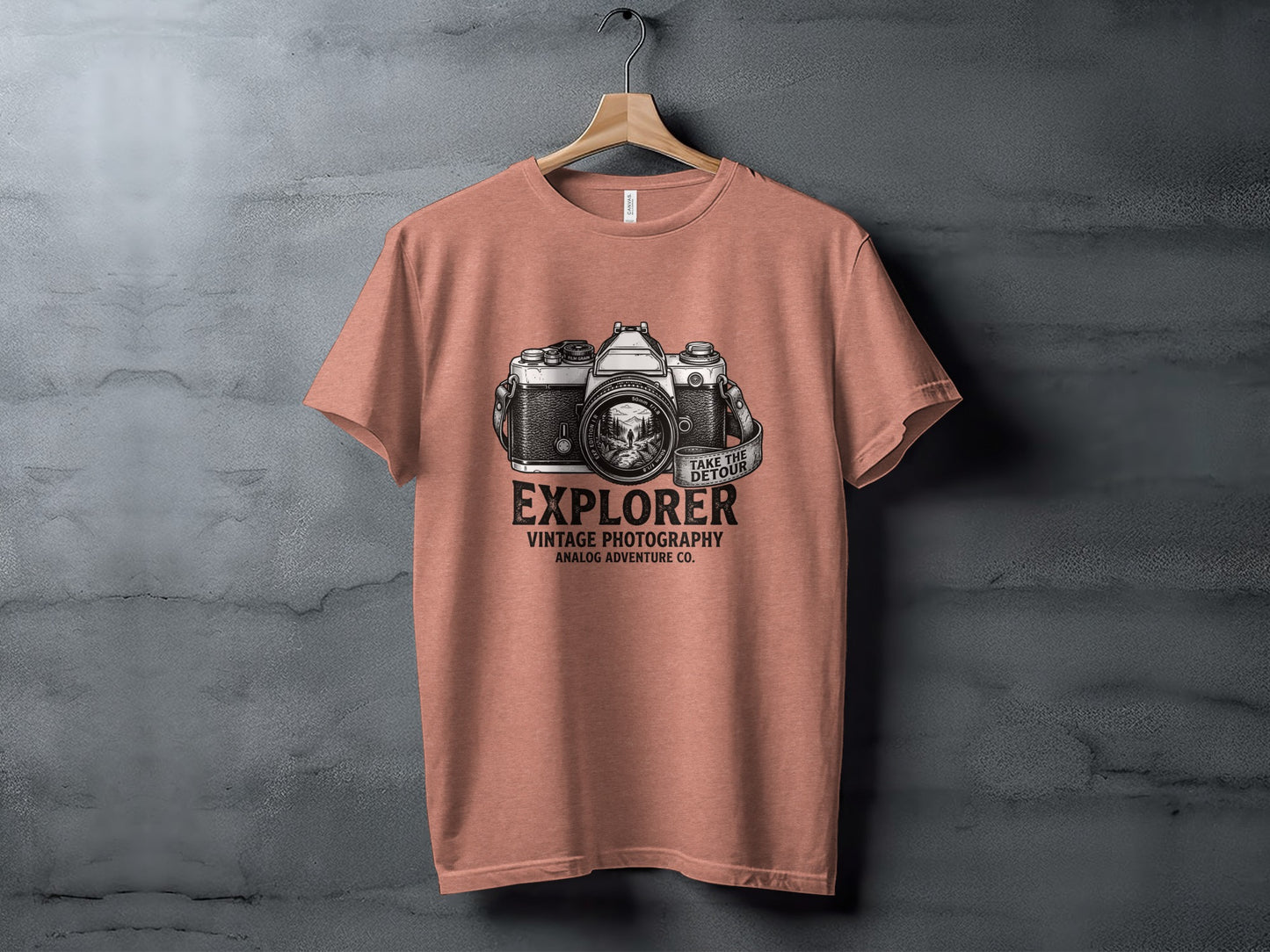 The Analog Explorer's Detour: Backcountry Outpost Shirt: Salmon t-shirt with vintage camera graphic and text "EXPLORER VINTAGE PHOTOGRAPHY ANALOG ADVENTURE CO."