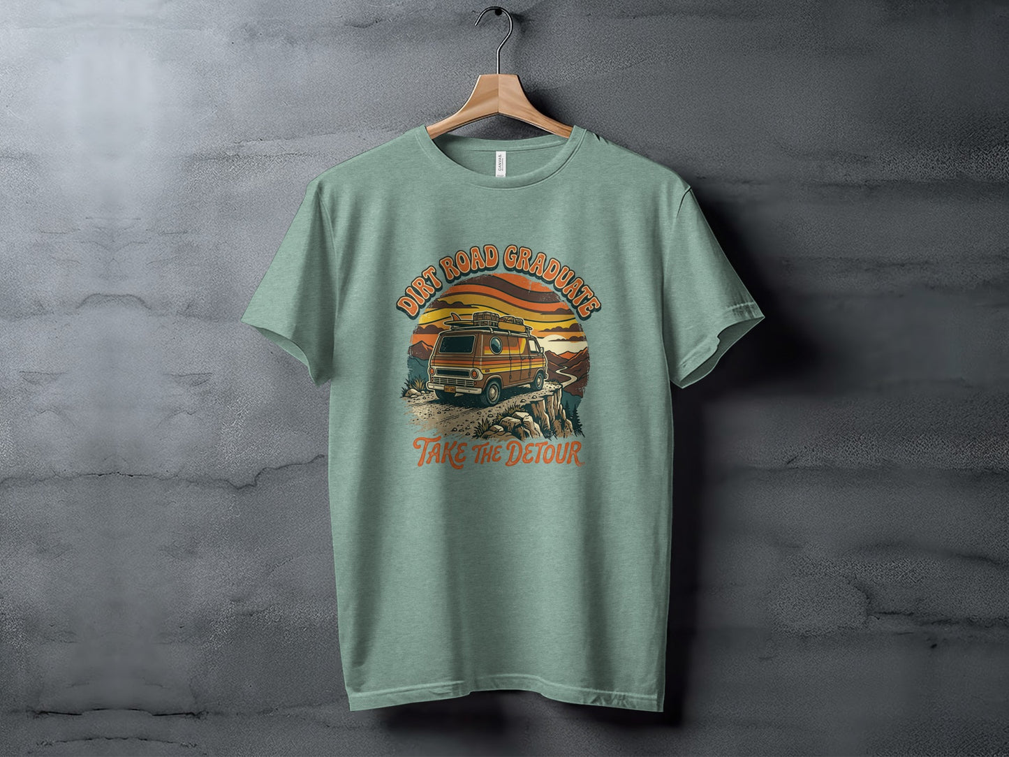 Heritage Dirt Road Graduate Adventure Tee Nomad Tee: T-shirt with a vintage van on a cliffside, "Dirt Road Graduates" and "Take the Detour" text.