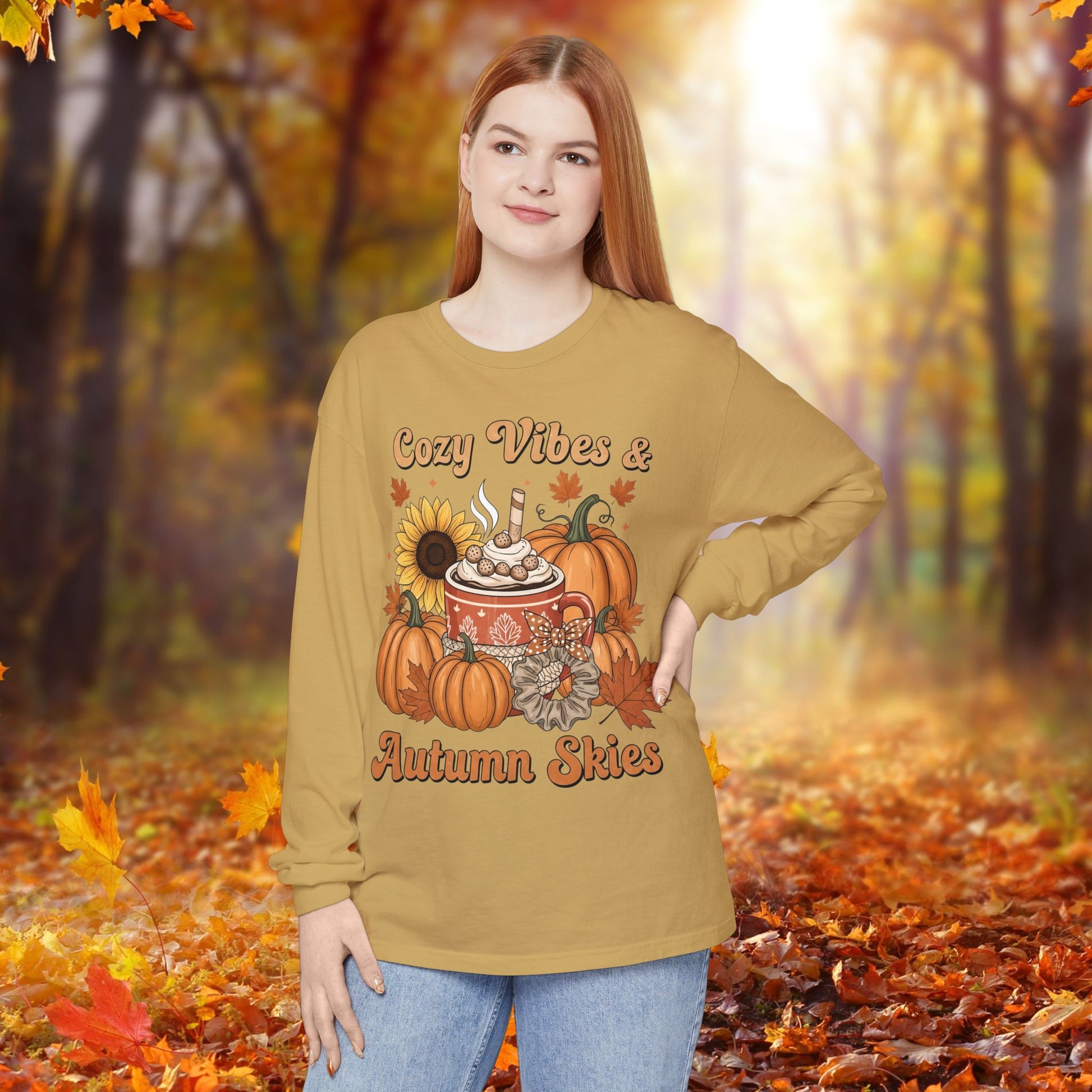 Woman wearing a mustard yellow long-sleeve shirt with autumn-themed design in an autumn forest setting.