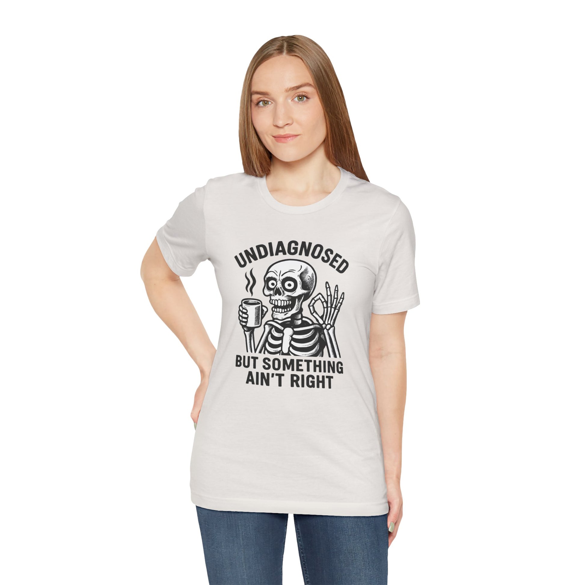 Woman wearing a white t-shirt with a skeleton graphic and text on a white background