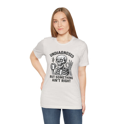 Woman wearing a white t-shirt with a skeleton graphic and text on a white background