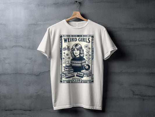 White t-shirt with "Weird Girls Club" text, retro cassette, books, flowers, and billiard ball.