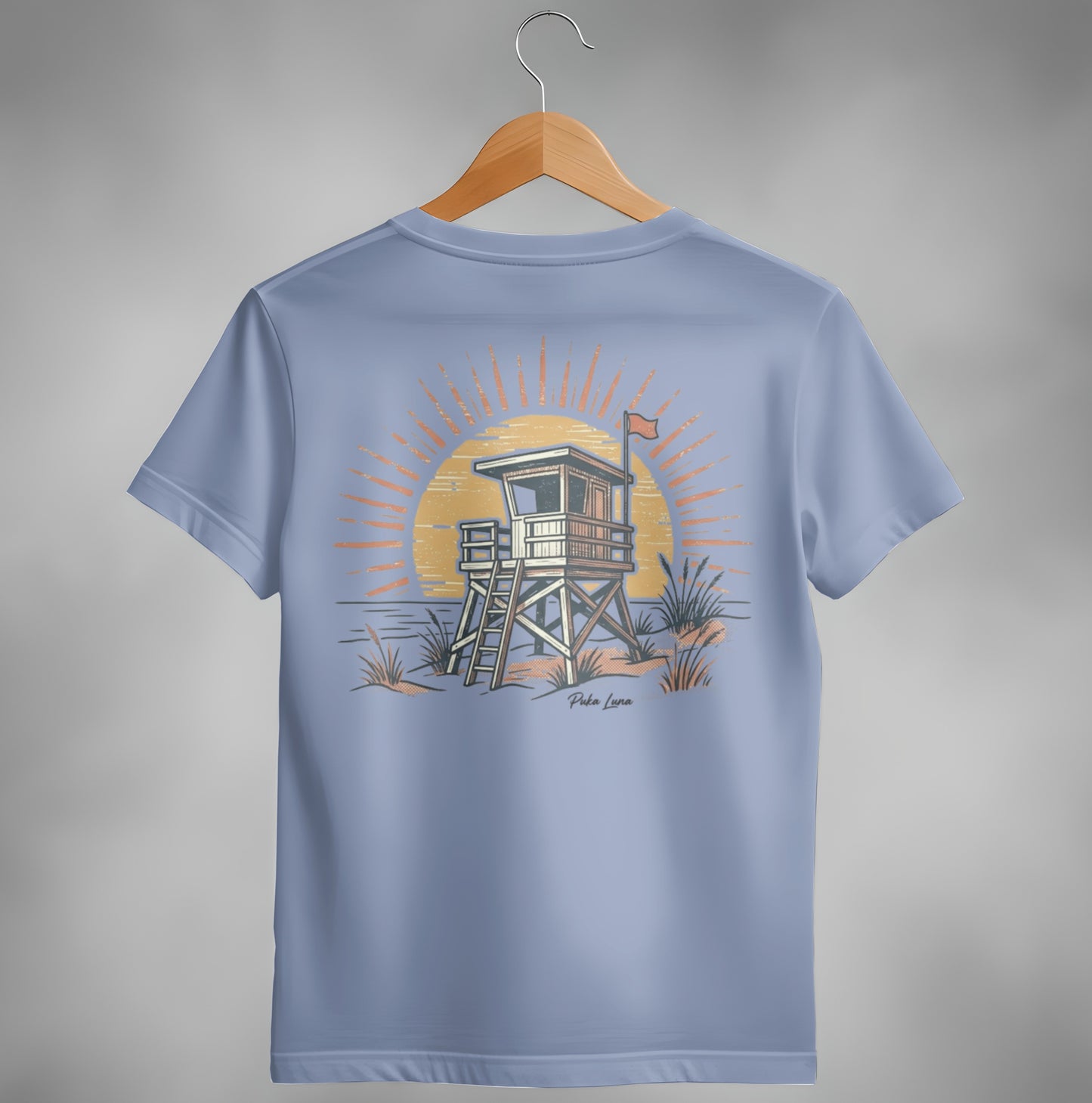 Lifeguard tower at sunset with "Pola Luna" text on a light blue t-shirt.