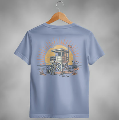 Lifeguard tower at sunset with "Pola Luna" text on a light blue t-shirt.