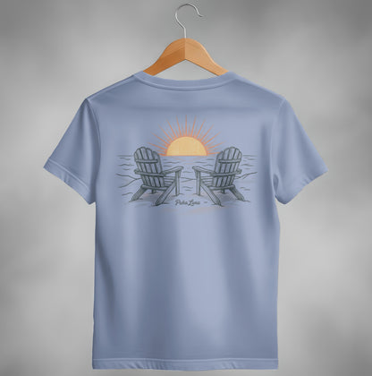 Two Adirondack chairs face a sunset over the ocean, with "Paka Luna" text.