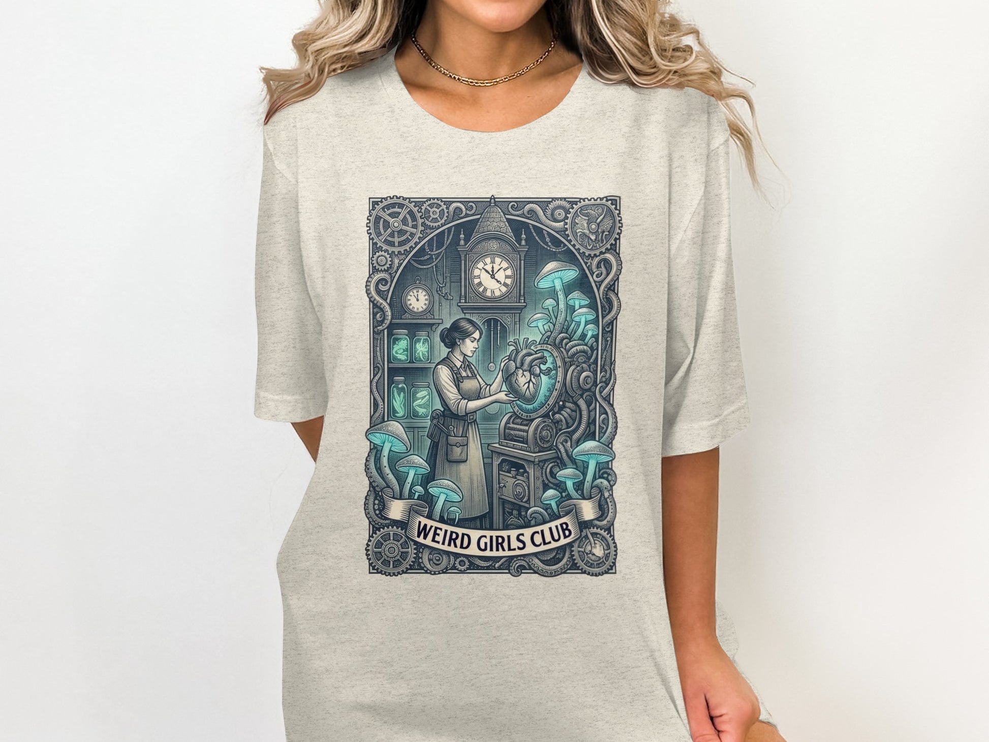 T-shirt graphic with steampunk mushrooms and a clockwork heart, "Weird Girls Club" text.