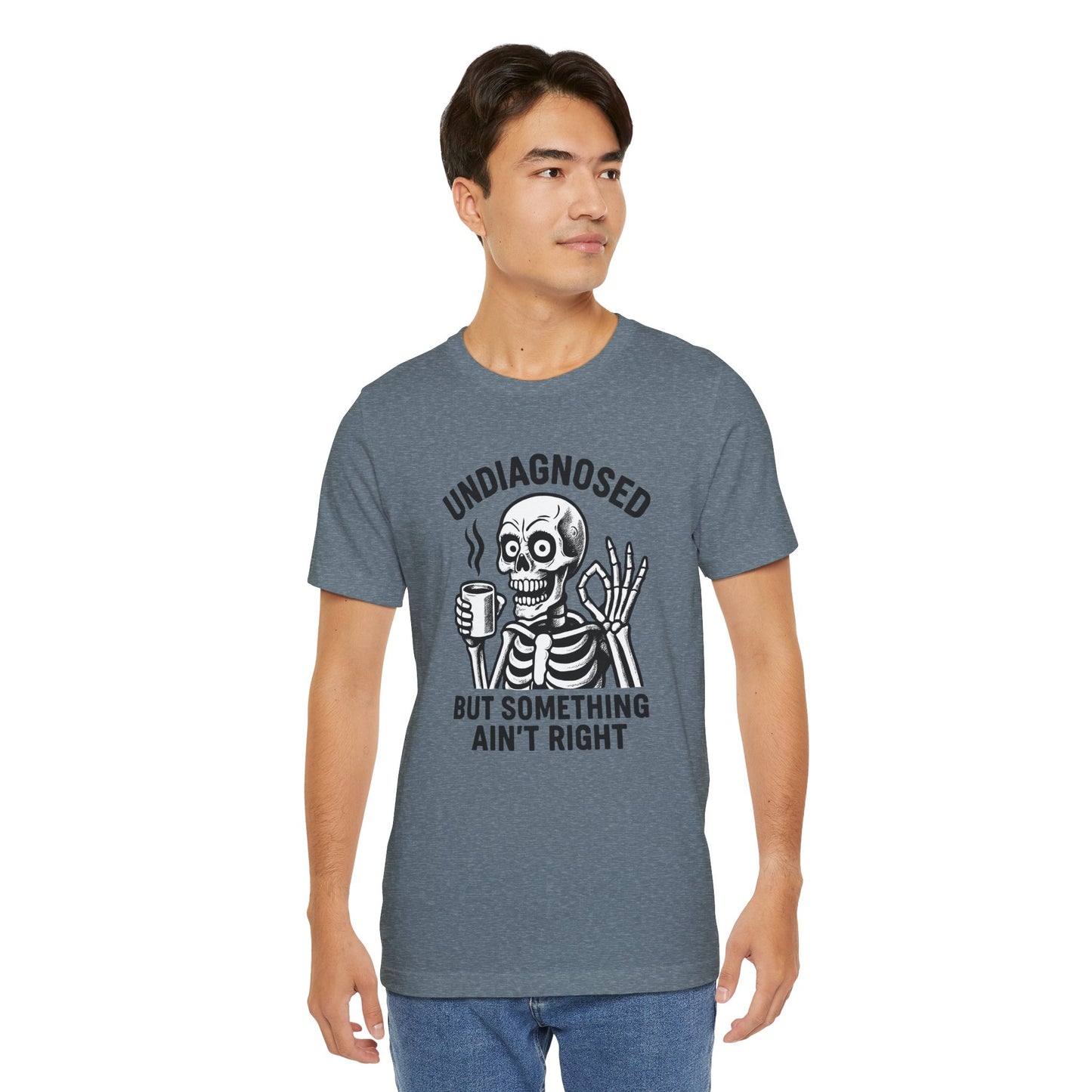 Man wearing a gray t-shirt with a skeleton graphic and text on a white background