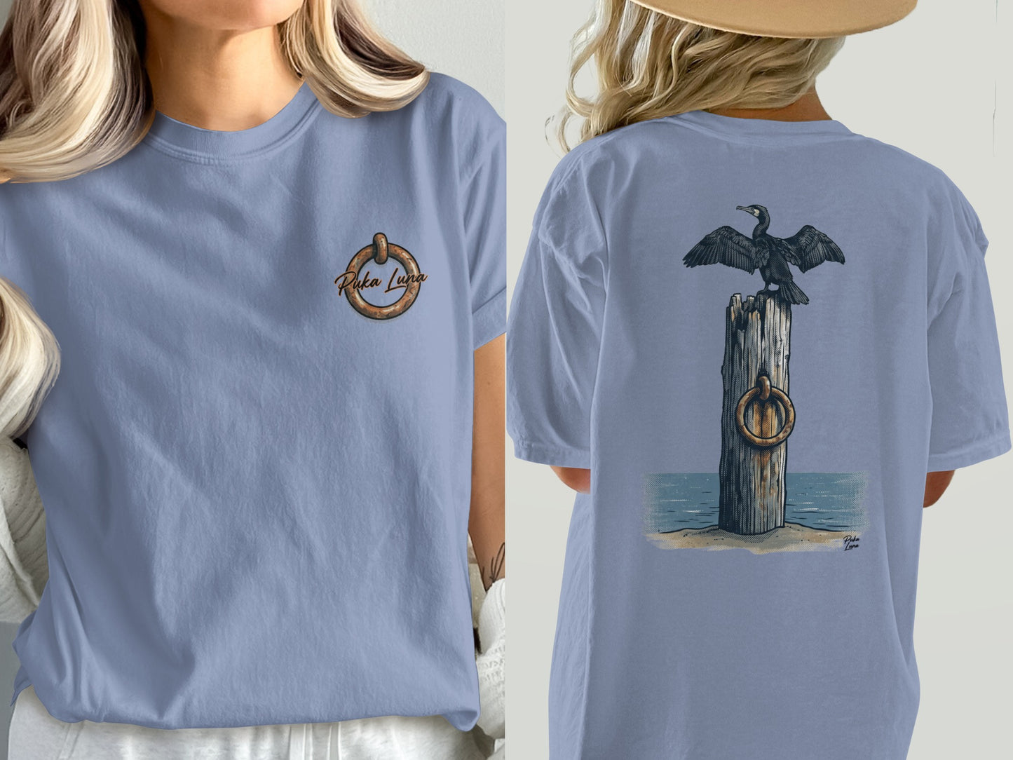 Two views of a light blue t-shirt featuring a cormorant perched on a wooden post.