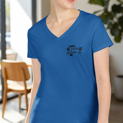 Blue v-neck t-shirt with "Table Talk" logo and two stools.